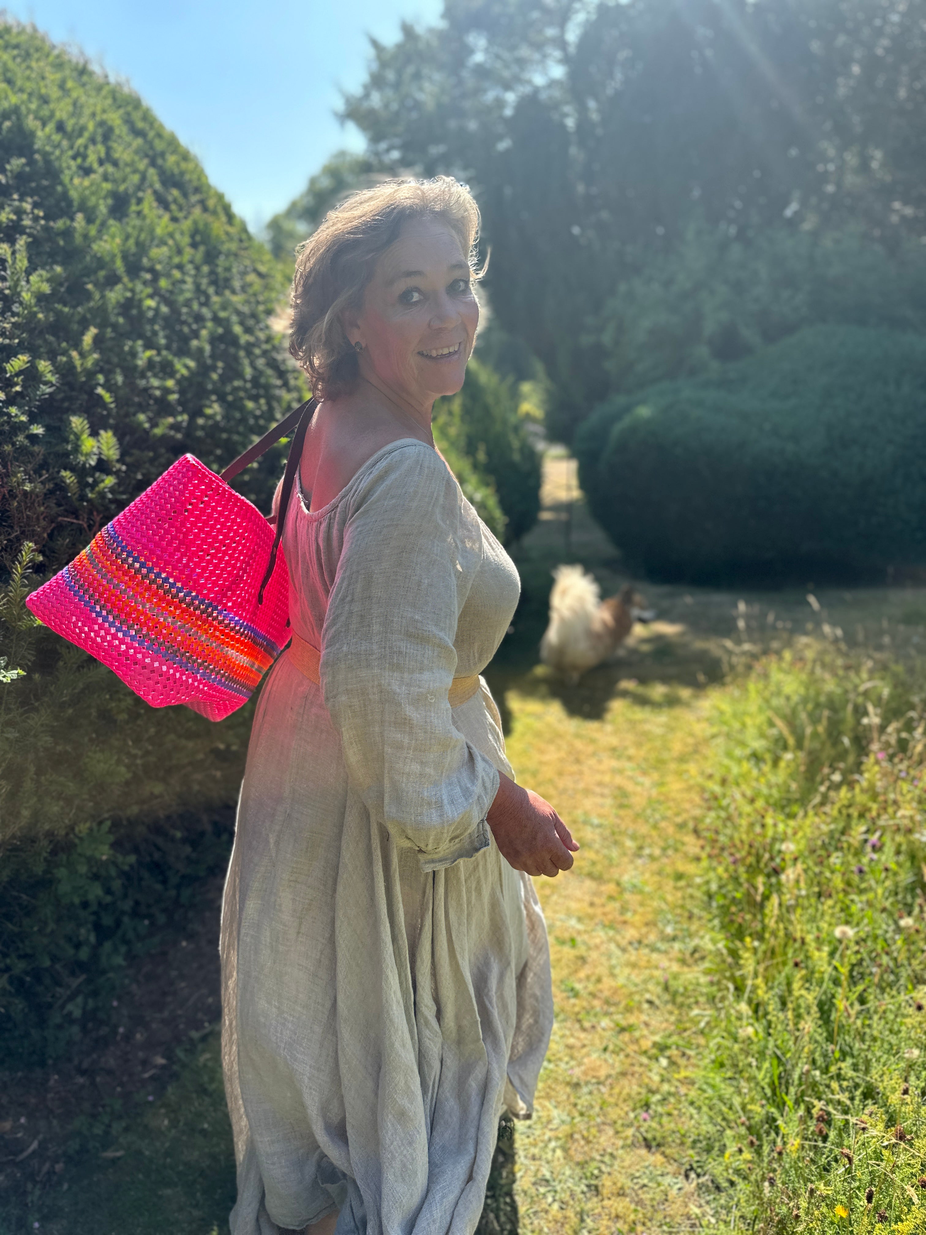 Woman walking in garden with bag