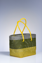 A woven tote bag with a three-tone color-blocked design: gray at the top, olive green in the middle, and bright yellow at the bottom, featuring two matching yellow shoulder straps, set against a light gray gradient background.