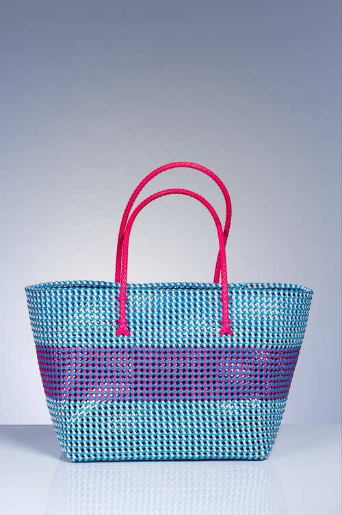 bright blue basket bag with pink handle 