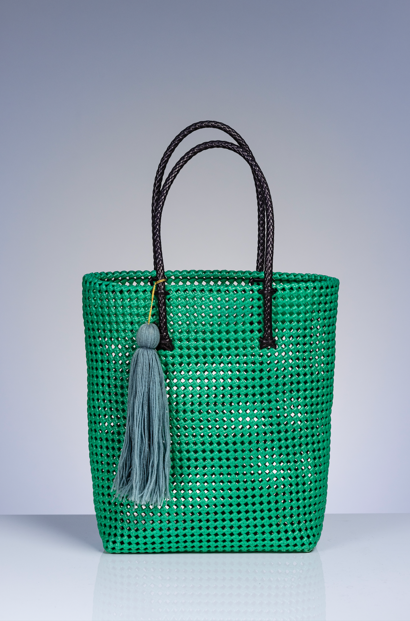 green tote bag with black handle